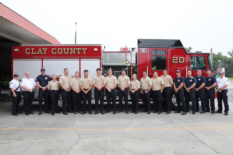 Non-certified recruits and members of Station 20 pose in front of Engine 20 before the "Push-In" ceremony.