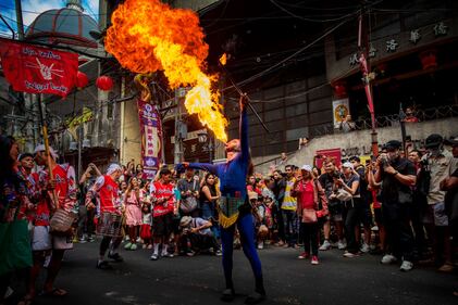 MANILA, PHILIPPINES - FEBRUARY 10: A performer breathes fire during Lunar New Year celebrations at Binondo district, considered the world's oldest Chinatown, on February 10, 2024 in Manila, Philippines. Lunar New Year, also known as Chinese New Year, is celebrated around the world, and the year of the Wood Dragon in 2024 is associated with growth, progress, and abundance, as wood represents vitality and creativity, while the dragon symbolizes success, intelligence, and honor.  (Photo by Ezra Acayan/Getty Images)