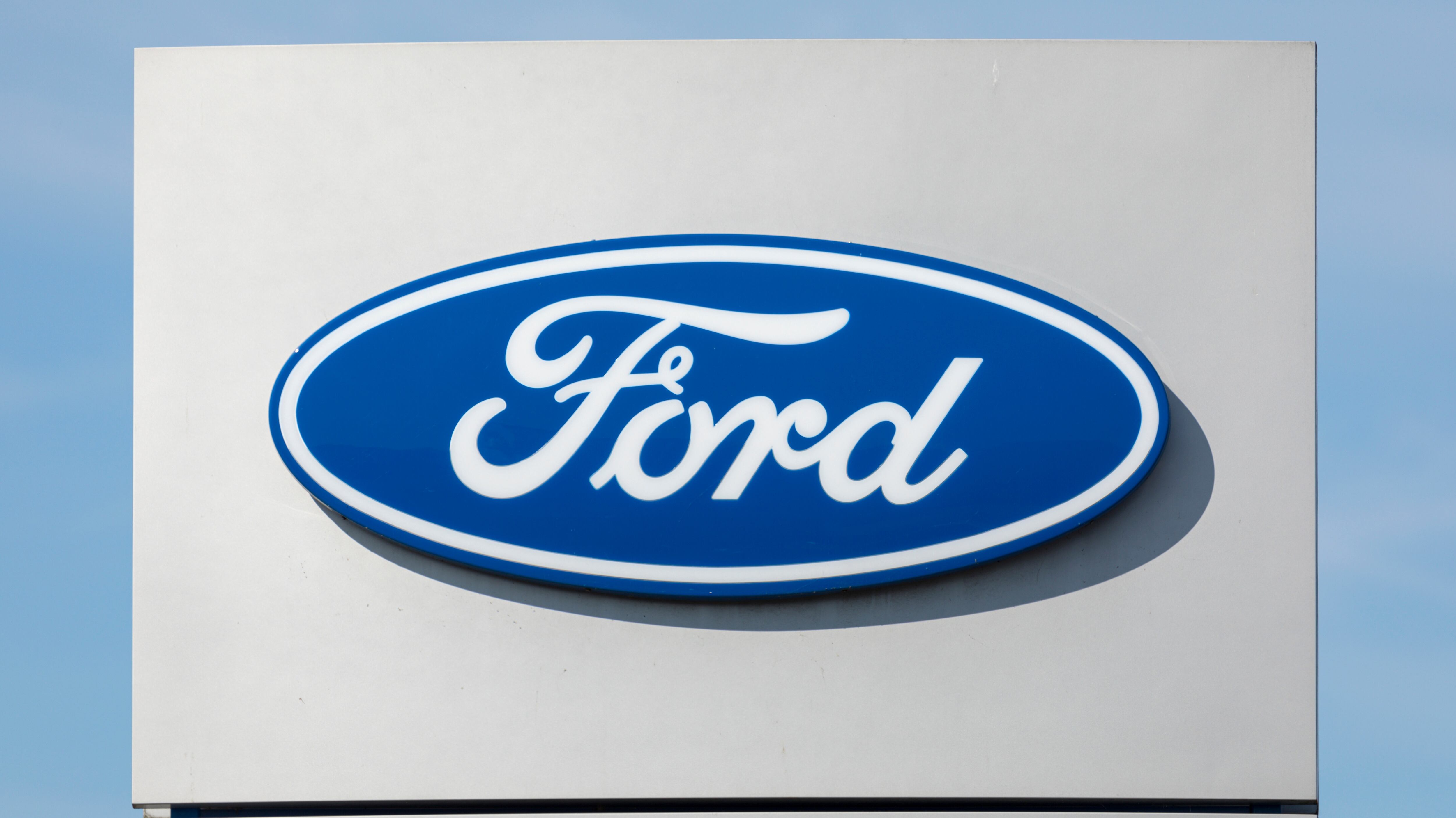 Logo on pole identifying a Ford Motor Company dealership