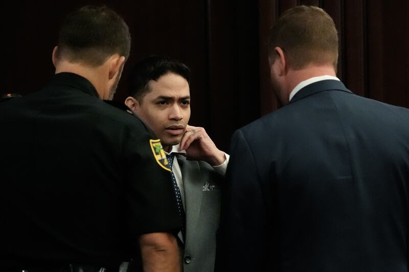 Defendant Mario Fernandez Saldana, center, fixes his tie and collar while talking with one of his defense attorneys Jesse Dreicer, right, before the start of jury selection in Saldana’s murder trial Monday morning, August 10, 2026 in the Duval County Courthouse in Jacksonville, Fla. [Doug Engle/Florida Times-Union]
