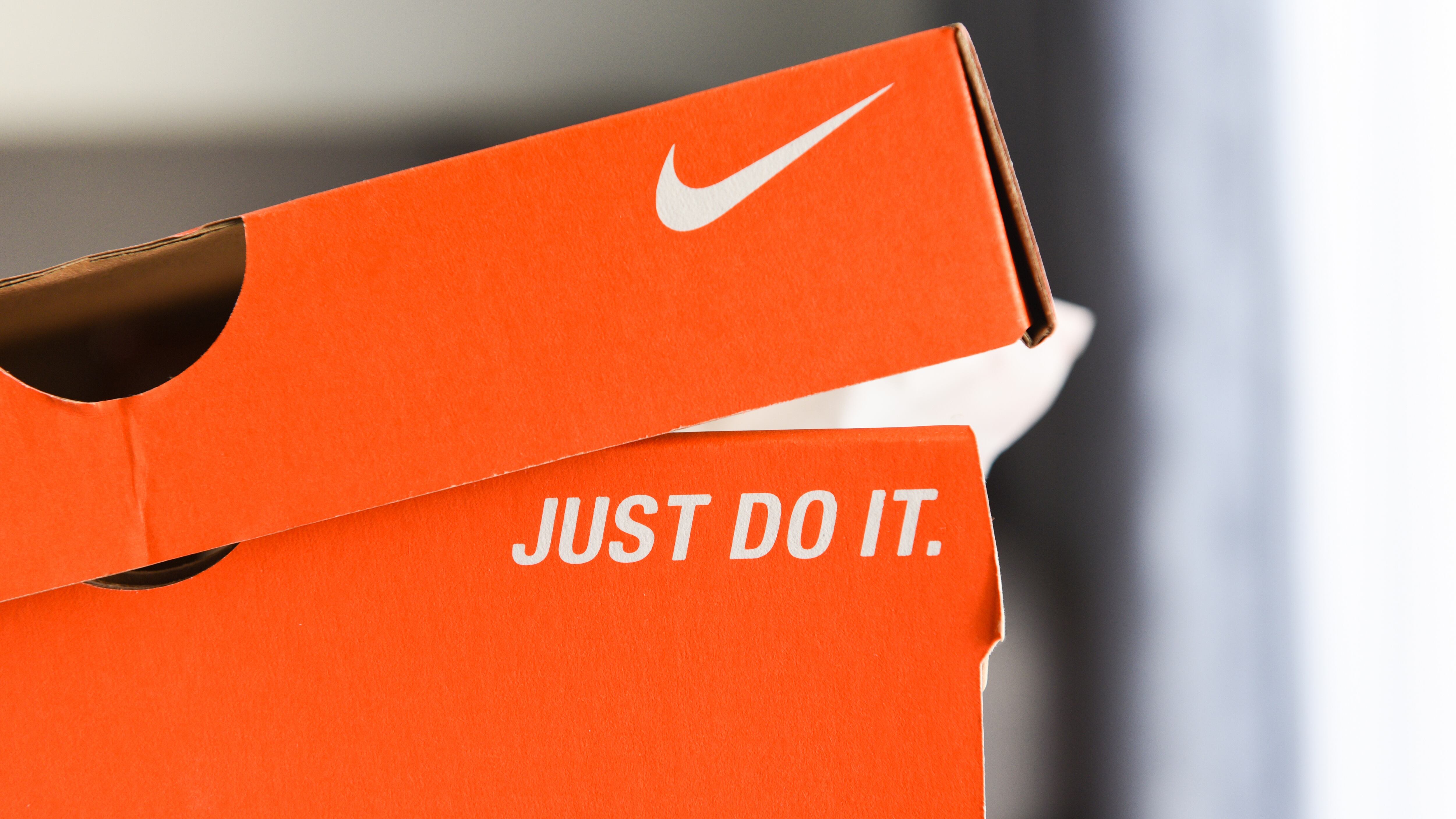 Nike running shoes box with Just Do It and nike logo on orange box in the store :