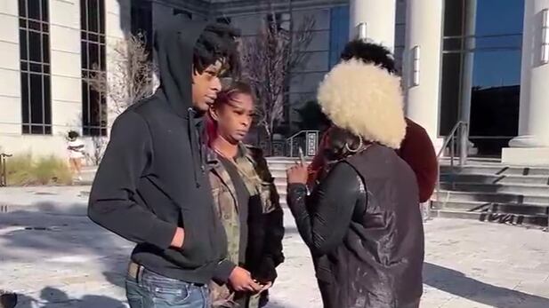 Le'Keian Woods (left) stands outside the Duval County Courthouse in January.