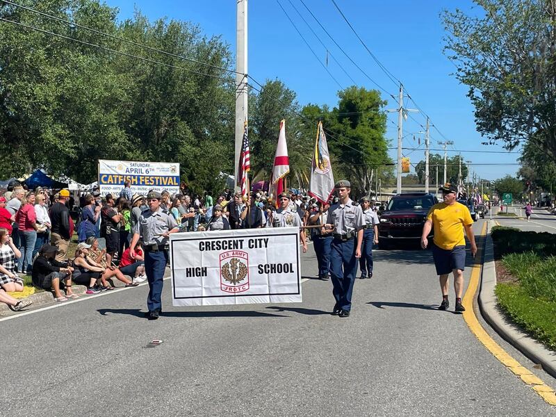 The Crescent City High School walks the street in today's parade.