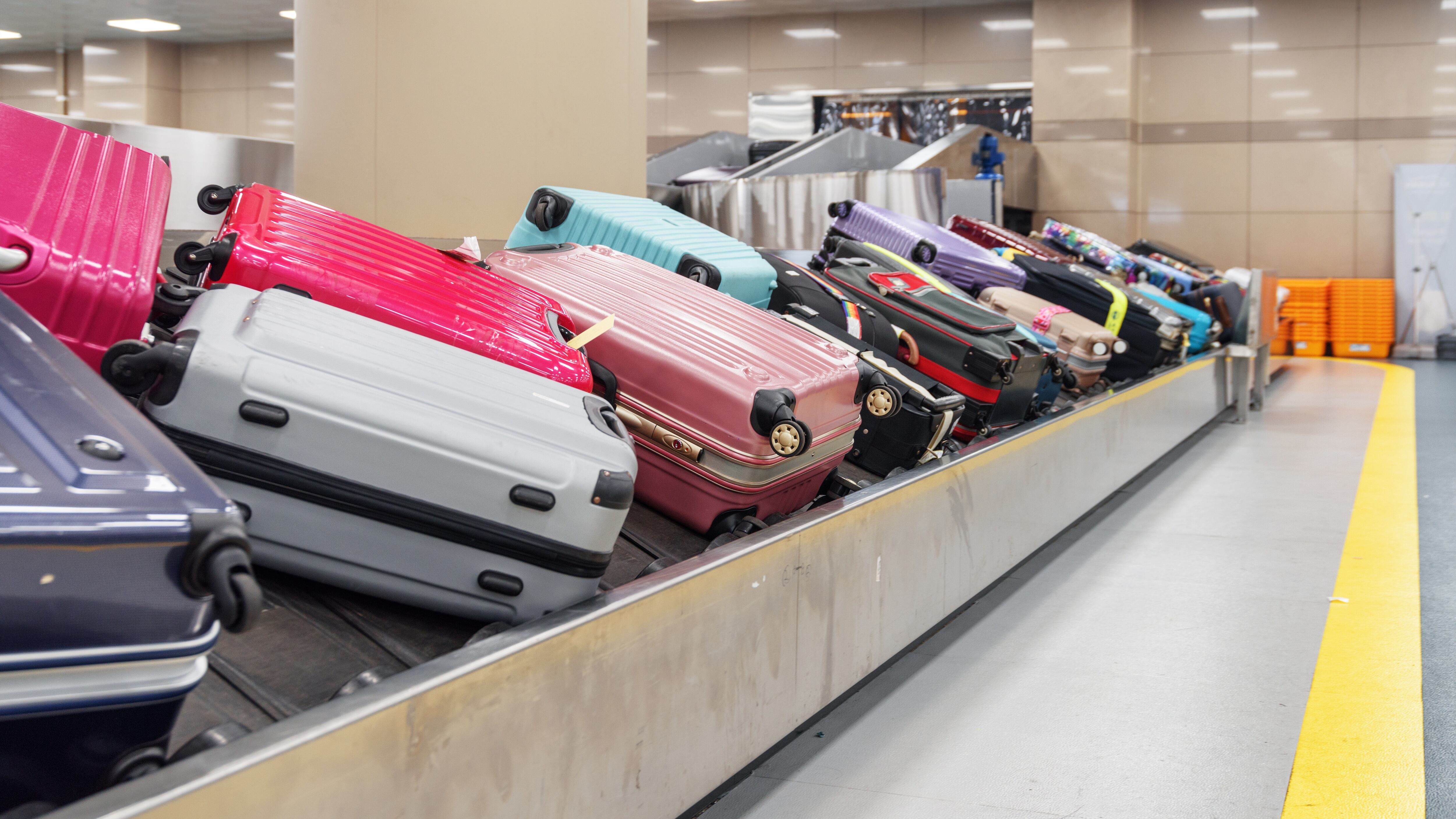 suitcases on the luggage conveyor belt at baggage carousel