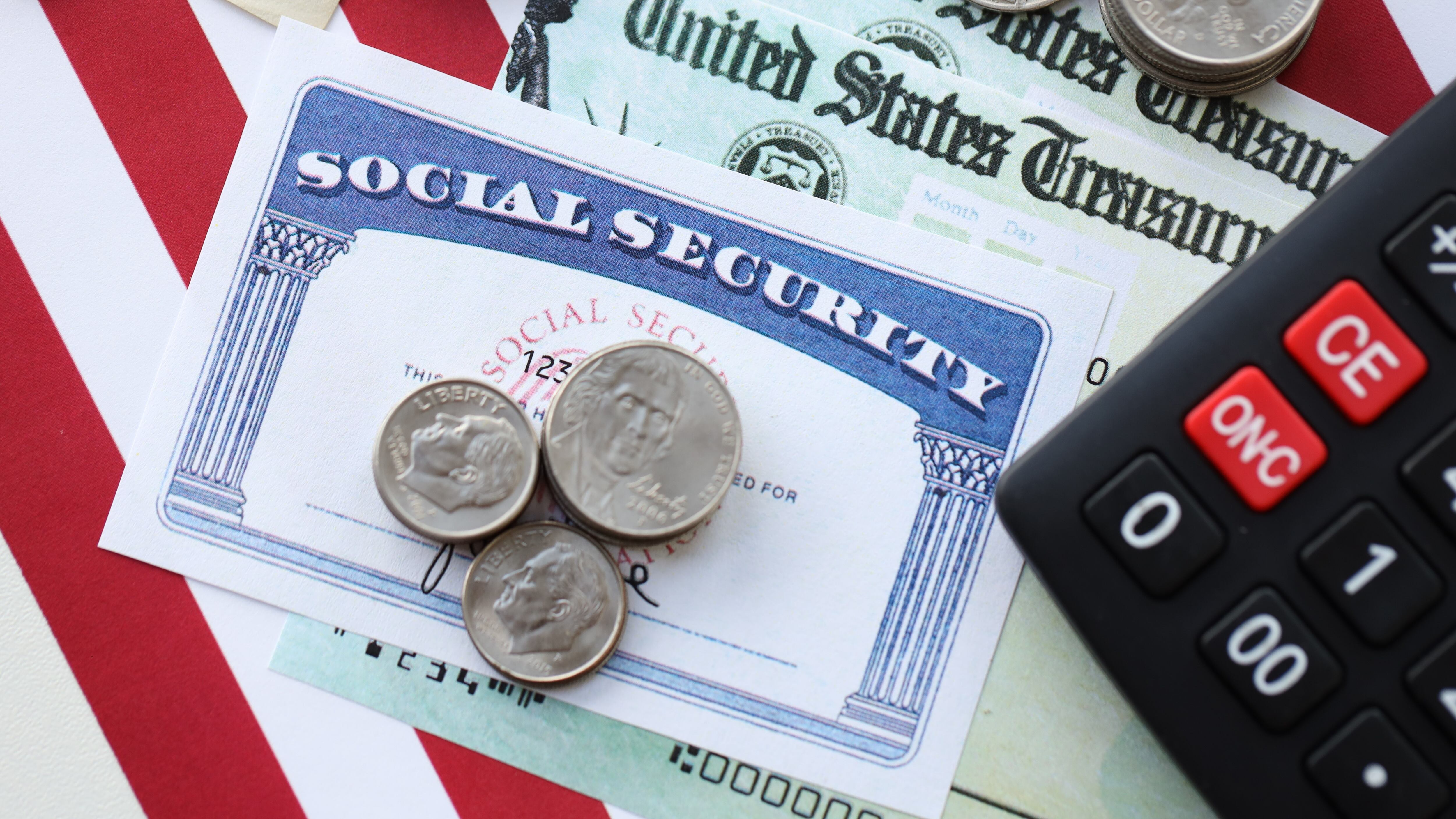 Social Security card, check, and change in front of an American Flag