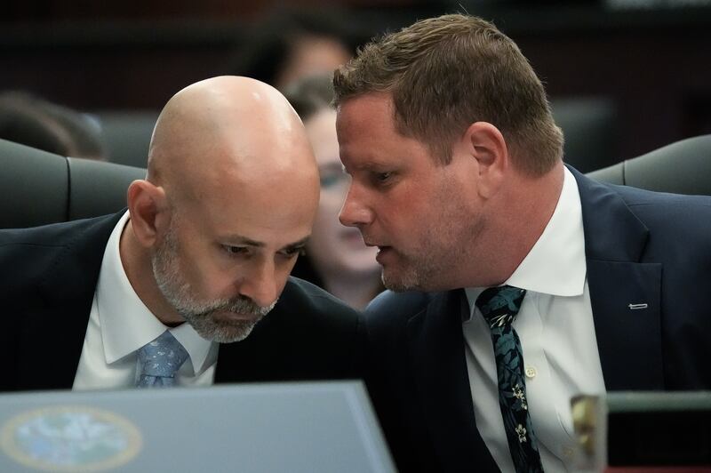 Defense Attorneys James Hill, left and Jesse Dreicer, right, whisper during jury selection in their client’s murder trial Monday morning, August 10, 2026 in the Duval County Courthouse in Jacksonville, Fla. [Doug Engle/Florida Times-Union]