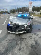 A stolen car slammed into the patrol car after reaching speeds over 100 MPH.