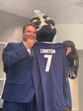 Ozzie The Osprey presents President Limayem with his own custom UNF jersey.