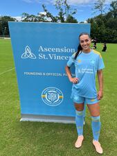 Midfielder Maddie Kemp showing off the team's jersey following Ascension St. Vincent's partnership announcement.