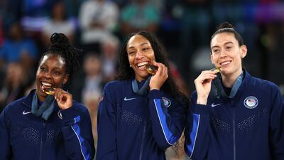 PARIS, FRANCE - AUGUST 11: Gold medalists Chelsea Gray, A'Ja Wilson, and Breanna Stewart of Team United States pose for a photo on the podium during the Women's basketball medal ceremony on day sixteen of the Olympic Games Paris 2024 at Bercy Arena on August 11, 2024 in Paris, France. (Photo by Gregory Shamus/Getty Images)