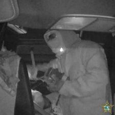 The suspect in the robbery was completely covered, wearing a jacket with a hoodie, a full-face mask, dark glasses, and gloves.
