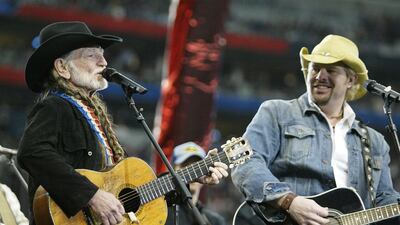 HOUSTON, TX - FEBRUARY 1: (L-R) Singers Willie Nelson and Toby Keith perform during the pre-game show prior to the start of Super Bowl XXXVIII between the New England Patriots and the Carolina Panthers at Reliant Stadium on February 1, 2004 in Houston, Texas. (Photo by Frank Micelotta/Getty Images)